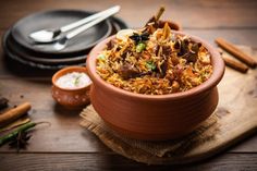 a bowl filled with food sitting on top of a wooden table