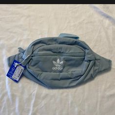 Adidas Originals National Ash Grey Blue Adjustable Waist Bag Fanny Pack. Casual Gray Bag With Adjustable Strap, Light Blue Casual Bags With Pockets, Casual Light Blue Bags With Pockets, Sporty Blue Shoulder Bag With Pockets, Blue Nylon Pouch Bag, Trendy Gray Bag For Outdoor Activities, Gray Nylon Softback Bag, Light Blue Casual Crossbody Bag, Casual Light Blue Crossbody Bag