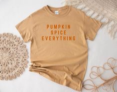 Pumpkin Spice Everything Tee Embrace the fall season with our Pumpkin Spice Everything Tee, perfect for both kids and adults! Made from 100% US cotton, this tee offers a soft and comfortable feel, making it ideal for any occasion. The classic fit and crew neckline provide timeless style, making it perfect for daily wear and festive celebrations alike, from Halloween to Thanksgiving. Product Features: 🖤 100% US Cotton: Soft and breathable for all-day comfort. 🖤 Classic Fit and Crew Neckline: A Pumpkin Harvest, Pumpkin Spice Everything, Kids Tops, Fall Season, Halloween Shirt, Pumpkin Spice, Crew Neckline, Coffee Lover, San Jose