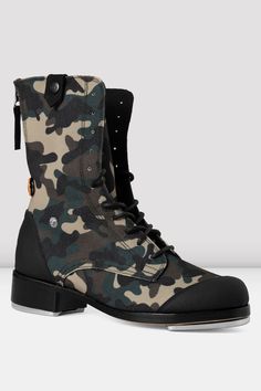 a pair of camouflage boots with black soles and laces on the side,