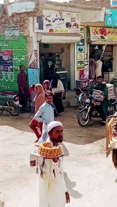 a man walking down the street carrying something in his hand