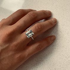 a person's hand with a ring on it