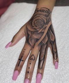 a woman's hand with tattoos on it and a rose tattooed on the palm