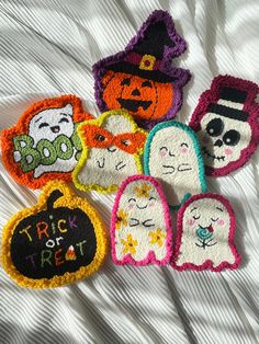 six embroidered ghost patches on a white sheet with pumpkins and jack - o'- lanterns