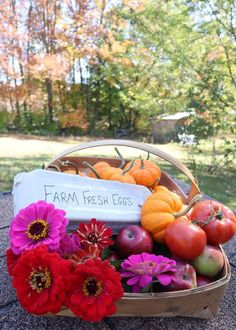 a basket filled with lots of different types of fruits and vegetables on top of a table