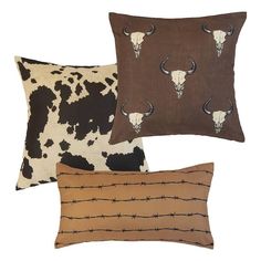 three pillows with longhorns and barbed wire on them