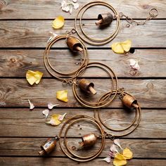 three necklaces with flowers on them sitting on a wooden surface