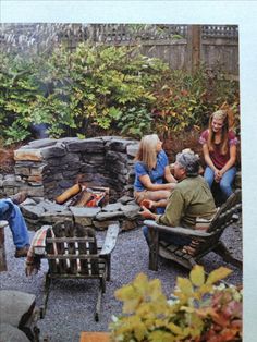 a group of people sitting around a fire pit