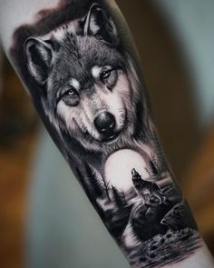 a wolf tattoo on the arm with an image of two wolfs in the background