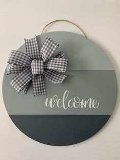 a welcome sign with a bow on it