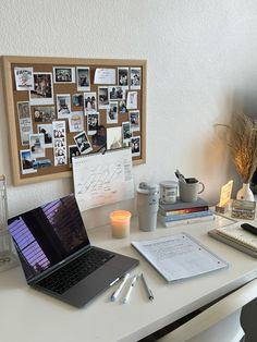 a laptop computer sitting on top of a white desk