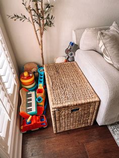 a living room with a couch, coffee table and toys