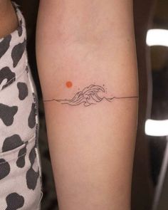 a woman's arm with an orange dot on the left side of her body