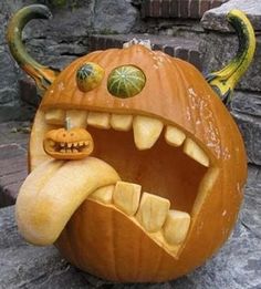 a carved pumpkin with teeth and fangs on it