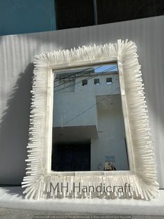 a mirror that is sitting on the side of a building