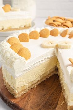 there is a cake with white frosting and banana slices on the top, along with other desserts