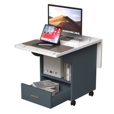 an open laptop computer sitting on top of a desk with a drawer underneath the keyboard