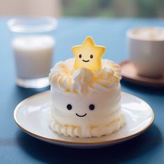 there is a small cake on the plate with a smiley face and star on top