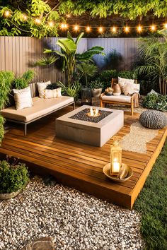 an outdoor living area with wooden decking and lights