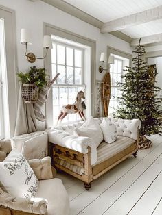 a living room filled with furniture and a christmas tree