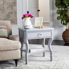 a white table with flowers on it in a living room