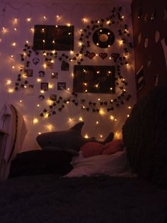 a bedroom decorated with lights and pictures on the wall