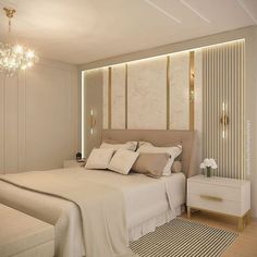 a large white bed sitting in a bedroom next to a wall mounted light above it