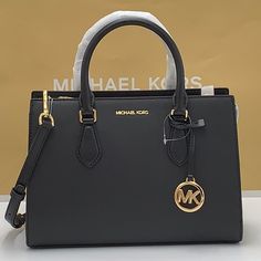 Brand New With Tag Michael Kors Sheila Medium Center Zip Satchel Bag Details Color: Black Satchel Faux Leather 88.92% Coated Canvas/11.08% Polyester Silver-Tone Hardware 11"W X 8"H 3.25"D Handle Drop: 4" Interior Details: Back Zip Pocket, 2 Front Slip Pockets Lining: 100% Polyester Zip Fastening Imported Michael Kors Black Satchel For Travel, Michael Kors Bag Outfit, Black Michael Kors Bag With Top Carry Handle, Classic Black Michael Kors Satchel, Michael Kors Black Satchel For Daily Use, Michael Kors Bag Black, Michael Kors Black Satchel With Gold-tone Hardware, Michael Kors Satchel, Black Satchel