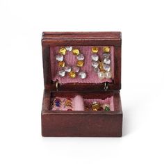 an open wooden box filled with lots of jewelry