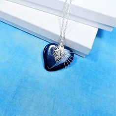 A Blue ceramic heart is artistically hand wire wrapped with non tarnish fine silver over copper wire to create a one of a kind pendant. he heart measures 1 3/4 inches by 1 3/4 inches and comes with a FREE coordinating chain with lobster claw clasp,measured to your preferred length. Your unique pendant necklace is ready to ship via USPS to your US location at no extra cost. (International shipping available. Please be aware of your local laws related to customs and VAT.) Hand Wrapped Heart Pendant Jewelry Gift, Wire Wrapped Jewelry For Valentine's Day Gift, Handmade Blue Heart Cut Jewelry, Sterling Silver Heart Necklace Wire Wrapped, Valentine's Day Wire Wrapped Jewelry Gift, Valentine's Day Gift Jewelry Wire Wrapped, Wire Wrapped Heart Pendant Jewelry Gift, Wire Wrapped Heart Pendant Necklace For Valentine's Day, Heart-shaped Wire Wrapped Necklace For Gift