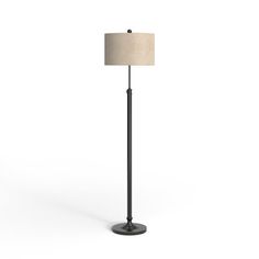 a black floor lamp with a beige shade on it's side and a white background