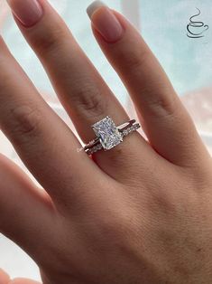 a woman's hand with a ring on it and a diamond in the middle