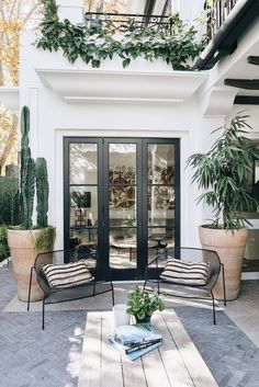 a patio with two chairs and a coffee table