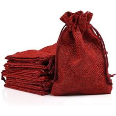 several red bags are stacked on top of each other in front of a white background