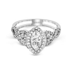 a white gold engagement ring with an oval cut diamond surrounded by small round brilliant diamonds