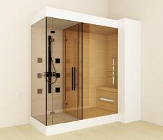 a bathroom with a walk in shower next to a tiled wall and wooden flooring