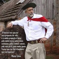 an older man wearing a red cape standing in front of a building with a quote written on it