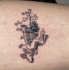 a tattoo on the back of a man's shoulder with a skeleton and flowers