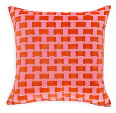 an orange and pink pillow on a white background