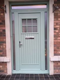 a green front door on a brick building