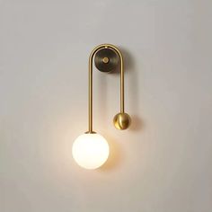 a light that is on the wall next to a white wall with a black handle