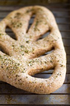 a pretzel is sitting on top of a baking rack, covered in seasoning