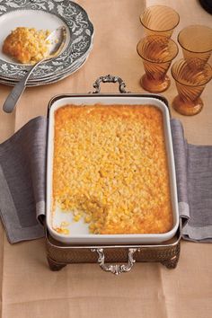 a casserole dish on a table with silverware