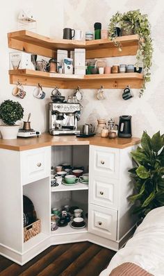 the corner of a room with shelves and pots