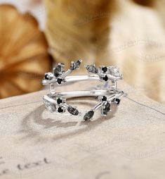 a stack of silver rings with black and white stones sitting on top of each other