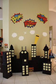 a room decorated in the style of comic book pages with black and white blocks, yellow letters and buildings