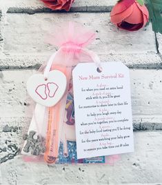 a new mom survival kit with flowers and a note attached to the back of it