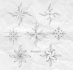 four snowflakes drawn on top of a piece of paper