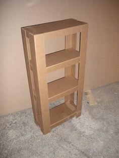 a cardboard shelf sitting on top of a carpeted floor