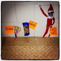 an elf is standing in front of a wall with signs on it